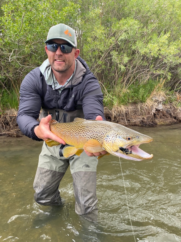 Happy angler with trophy brown trout